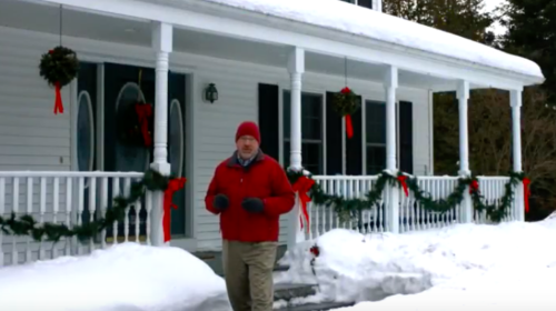 snowy porch and man in winter gear