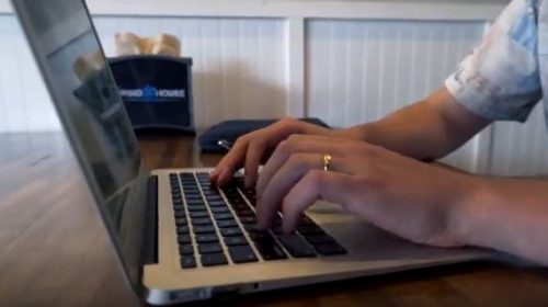 hands typing on laptop