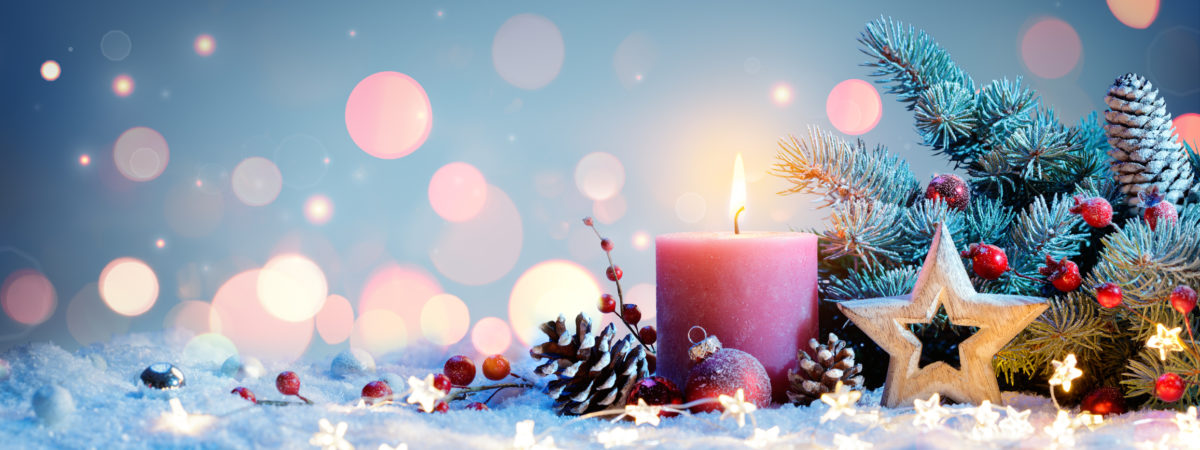 red candle with christmas decorations